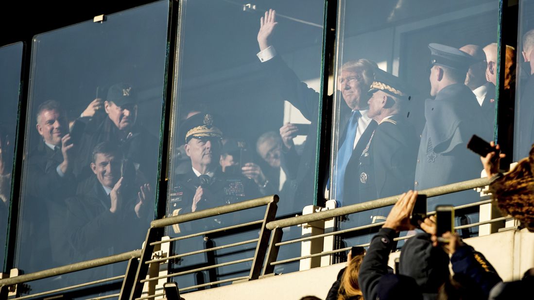 Trump waves during the Army-Navy football game, which was played in Baltimore on Saturday, December 10. 