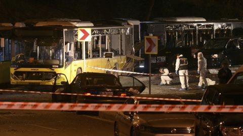 Forensic officials work at the scene of explosions near a stadium in Istanbul.