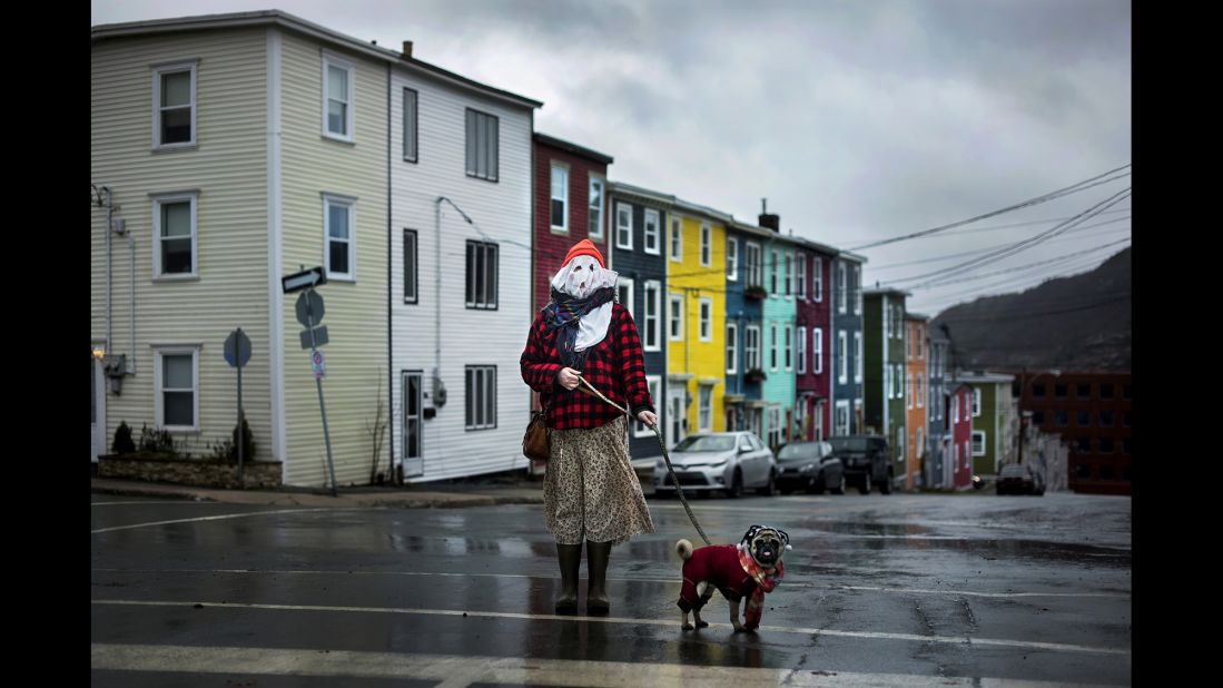 Sarah Ferguson and her dog Frank stand in traditional mummer dress in St. John's, Newfoundland. Mummering involves getting dressed up in disguise using anything one can scavenge -- curtains, lampshades, old clothing -- before going unannounced to neighbors' homes for impromptu kitchen parties. The centuries-old Christmas tradition all but disappeared in Newfoundland and Labrador, but a new generation is starting to revive it, according to photographer Darren Calabrese.