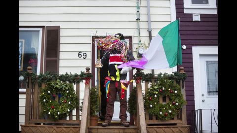 Wally Upward stands on his home's porch while dressed as a "ribbon fool."