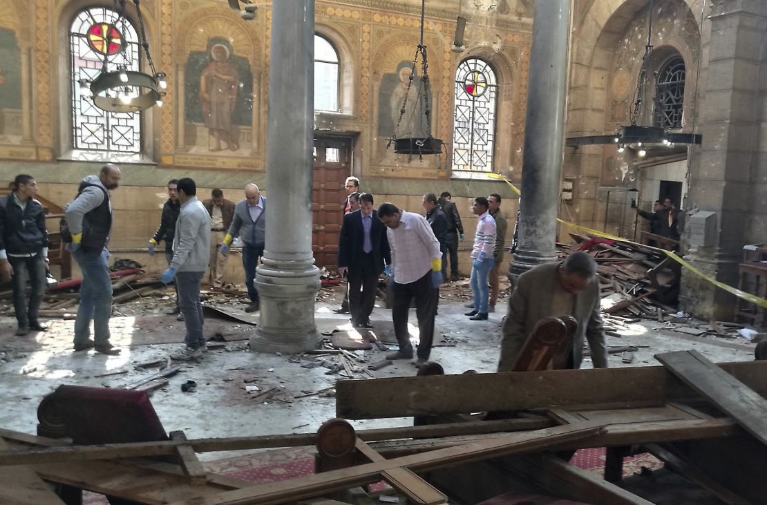 Egyptian security forces examine the scene inside the cathedral Sunday.