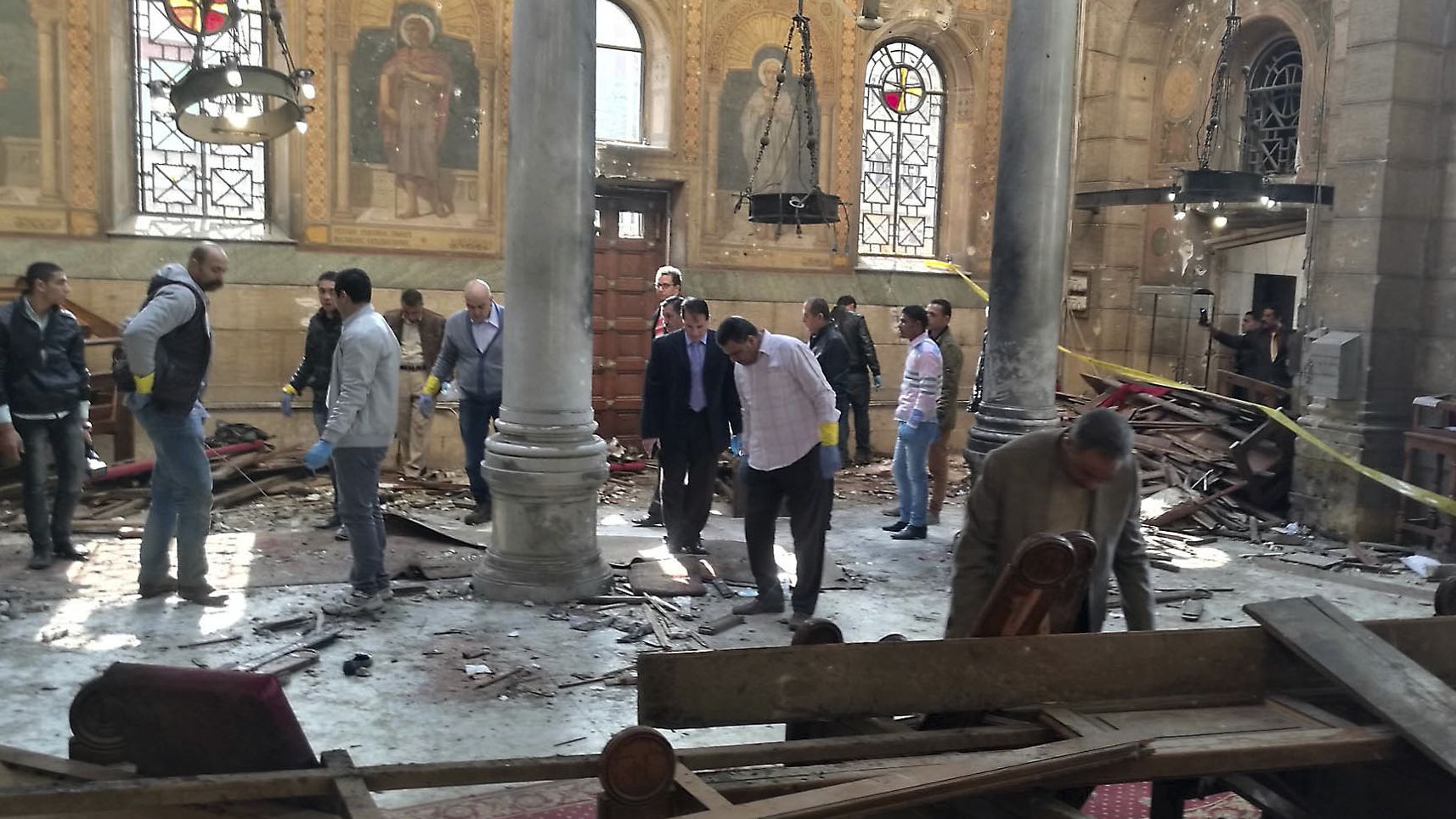 Egyptian security forces examine the scene inside St. Mark Cathedral in central Cairo, following a bombing, Sunday, Dec. 11, 2016.  