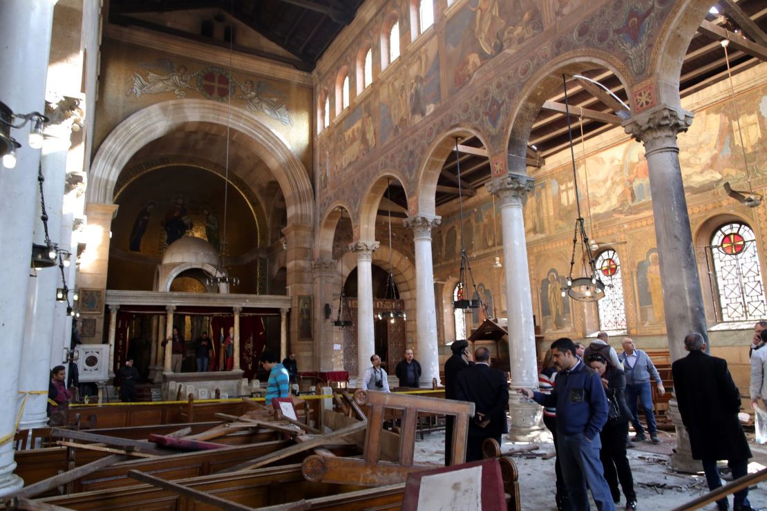  Security officials and people inspect the damage inside St. Peter and St. Paul Coptic Orthodox Church after a bombing in Cairo, Egypt, 11 December 2016. 