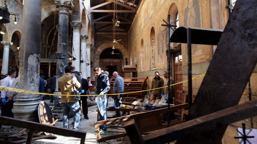 Security officials and people gather at the St. Peter and St. Paul Coptic Orthodox Church after a bombing in Cairo, Egypt on December 11, 2016. Reports state at least 20 people were killed and 35 injured in the explosion outside Cairo's Coptic Cathedral in the Abbassia neighborhood. 