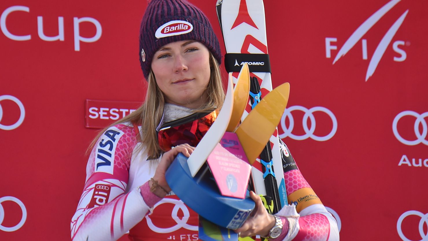 Mikaela Shiffrin celebrates on the podium after winning the women's slalom.