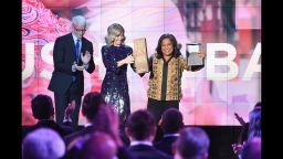 NEW YORK, NY - DECEMBER 11:  Anderson Cooper and Kelly Ripa present an award to CNN Superhero and 2012 CNN Hero of the Year Pushpa Basnet onstage during the CNN Heroes Gala 2016 at the American Museum of Natural History on December 11, 2016 in New York City.26362_013  (Photo by Michael Loccisano/Getty Images for Turner)
