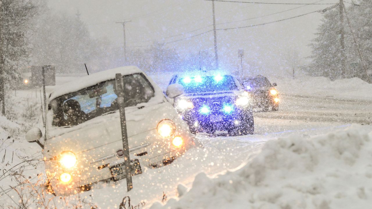 Chesterfield, N.H., police help out a motorist that slid off the road during a snow storm Monday, Dec. 12, 2016, in Chesterfield, NH. Snow and freezing rain made for messy commutes and closed hundreds of schools Monday as a snowstorm pushed into the Northeast. (Kristopher Radder/The Brattleboro Reformer via AP)