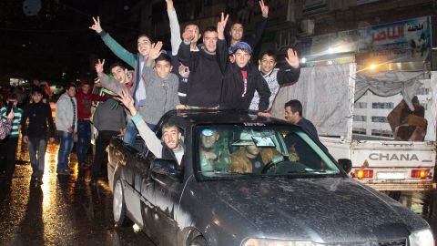 Citizens celebrate on the streets of Aleppo on Monday after regime forecs recaptured the al-Sheik Saeed and al-Sukkari neighborhoods.