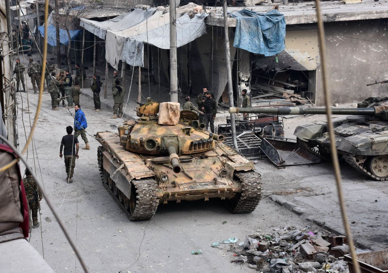 Pro-government forces patrol the al-Saleheen neighborhood in eastern Aleppo on December 12.