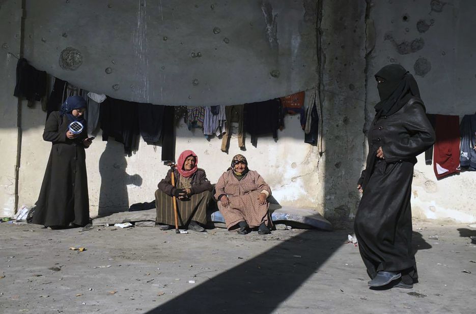 In this handout photo from the International Committee for the Red Cross, women displaced from eastern Aleppo gather at a shelter in the village of Jibreen, south of Aleppo, on December 12.