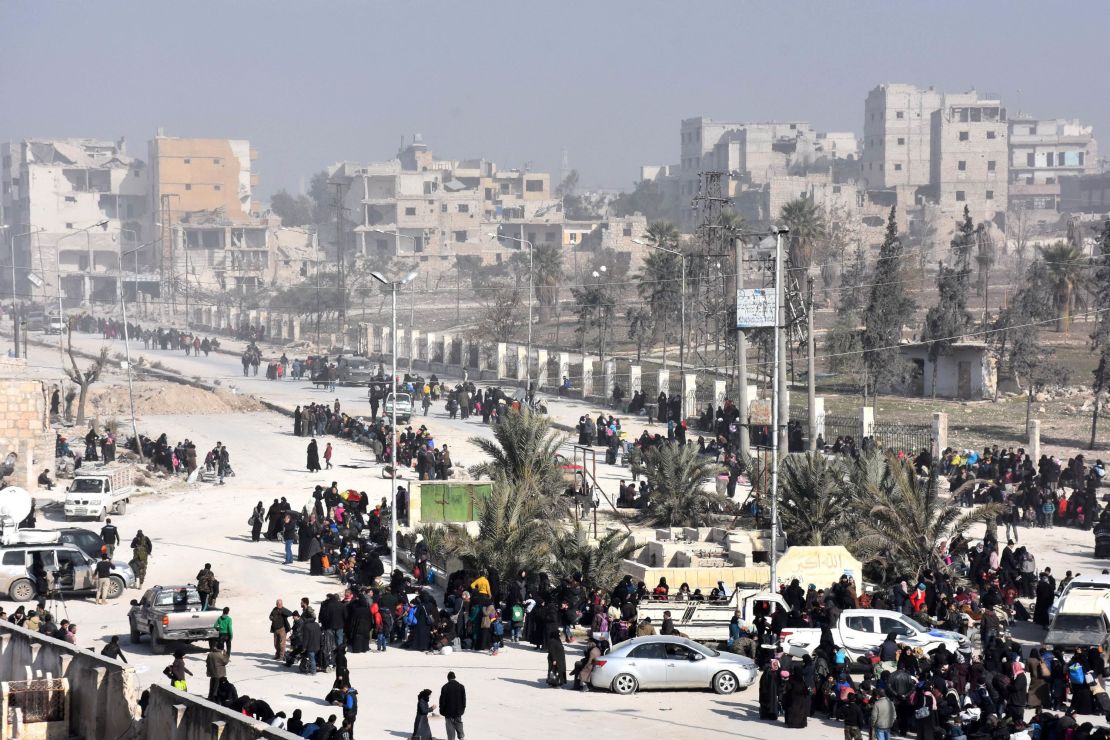 Syrian civilians arrive at a pro-government checkpoint after leaving Aleppo's eastern neighbourhoods on Saturday.