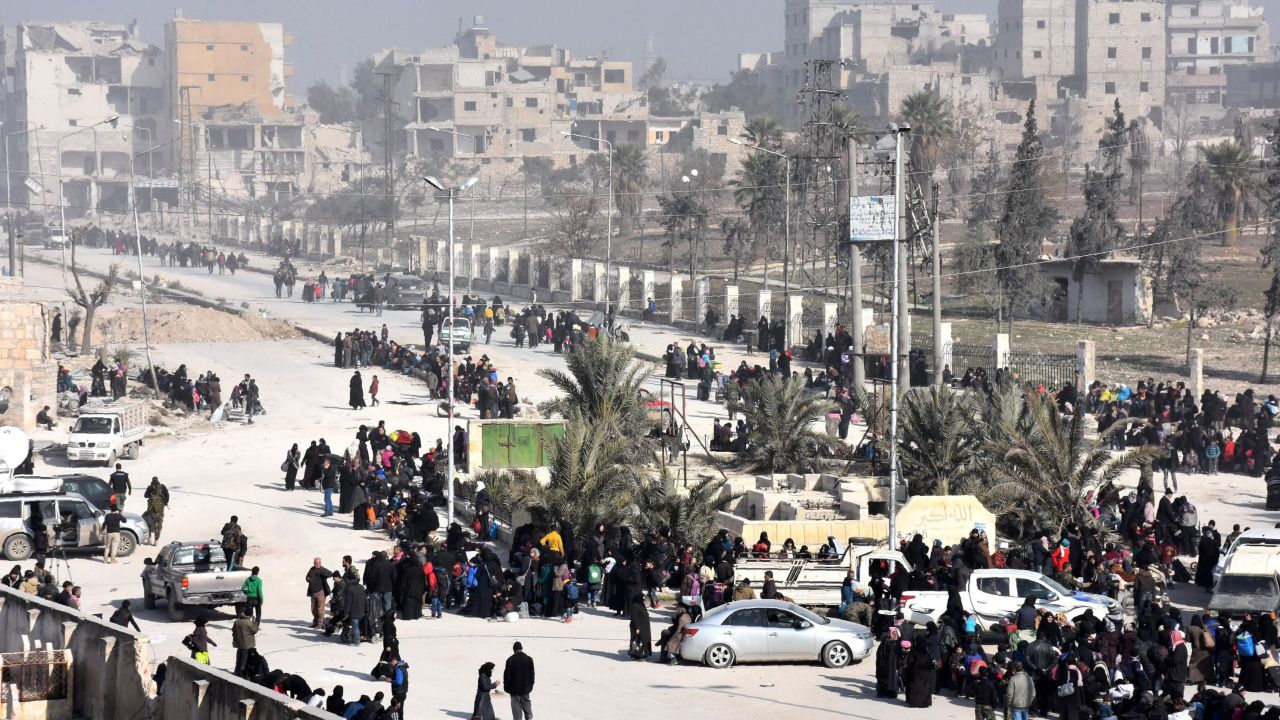 Syrian civilians arrive at a pro-government checkpoint after leaving Aleppo's eastern neighbourhoods on Saturday.