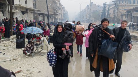 Residents flee the Bustan al-Qasr neighbourhood in eastern Aleppo on Tuesday.