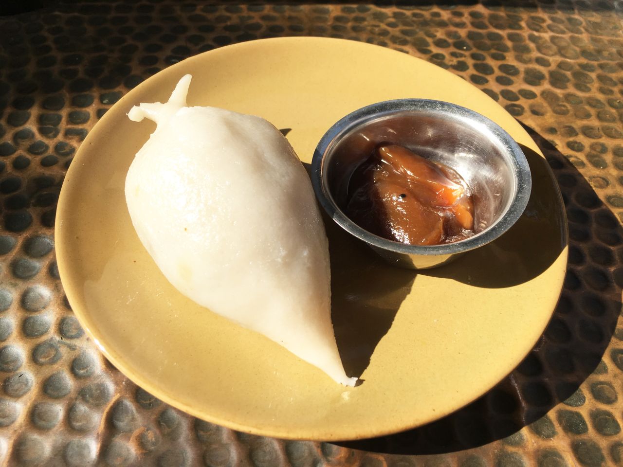This steamed rice bun is a dessert, containing runny sweet fillings.