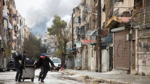 Smoke is seen billowing in the background on December 14, 2016 in this picture taken in a rebel-held neighbourhood in the northern city of Aleppo.
Deadly clashes erupted in Syria's Aleppo as a deal for the evacuation of rebel areas was put on hold, leaving thousands of cold and hungry civilians uncertain of their future
/ AFP / KARAM AL-MASRI (Photo credit should read KARAM AL-MASRI/AFP/Getty Images)