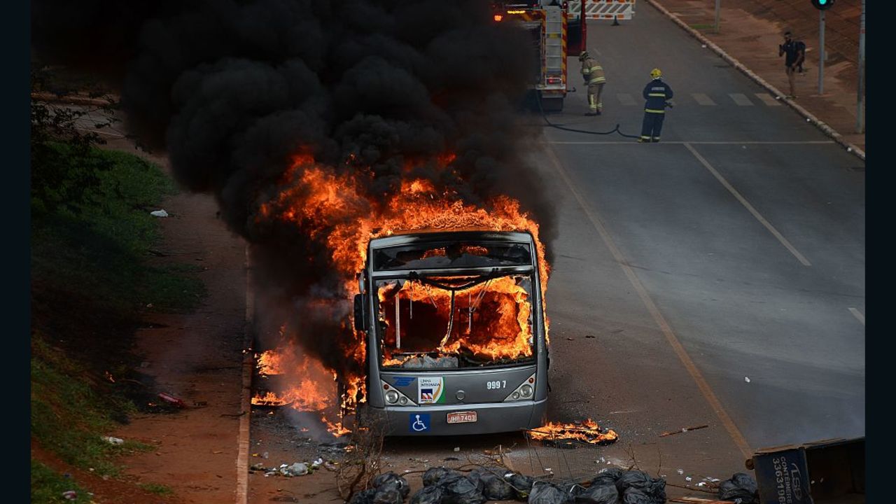 Students set buses on fire during a protest in front of the National Congress in Brasilia on December 13, 2016. 