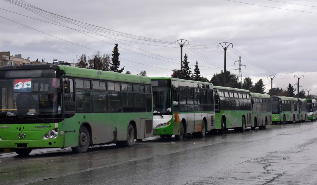 Buses wait to evacuate people in Aleppo on December 14.