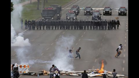 Demonstrators face-off with police in the city of Brasilia on Tuesday, December 13.
