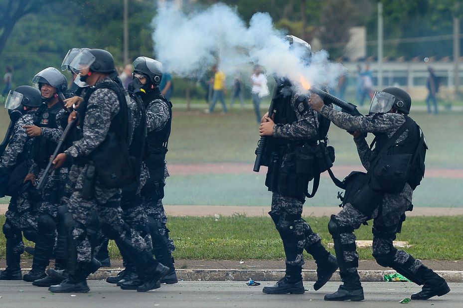 Riot police fire tear gas grenades at protesters in Brasilia on December 13.