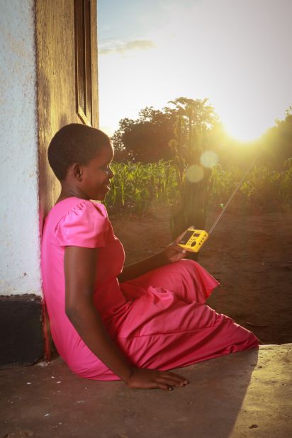 A young Tanzanian girl enjoys music in Tanga region from a solar powered radio.
