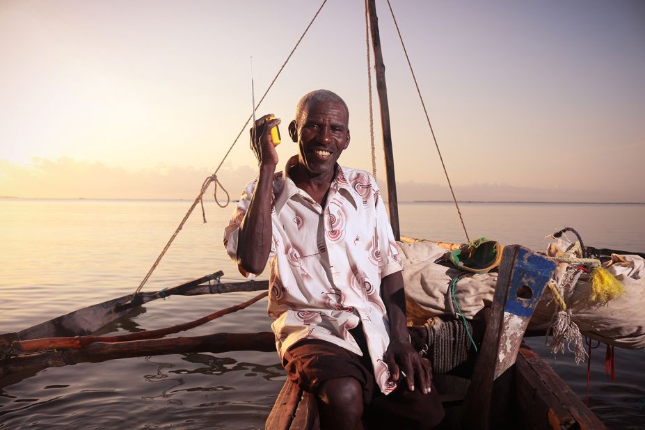 A fisherman in Tanga, Tanzania brings his solar radio with him to listen to the news while working.