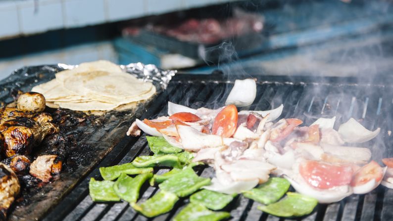 Before seeing the famed tacos, you'll be greeted with its smell first. Smoke pours from the kitchen onto the street, perfuming the area with the aroma of charcoal and grilling meats. 
