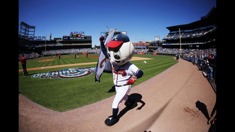 Homer, a walking baseball head, warms up before the 2016 home opener at Turner Field.