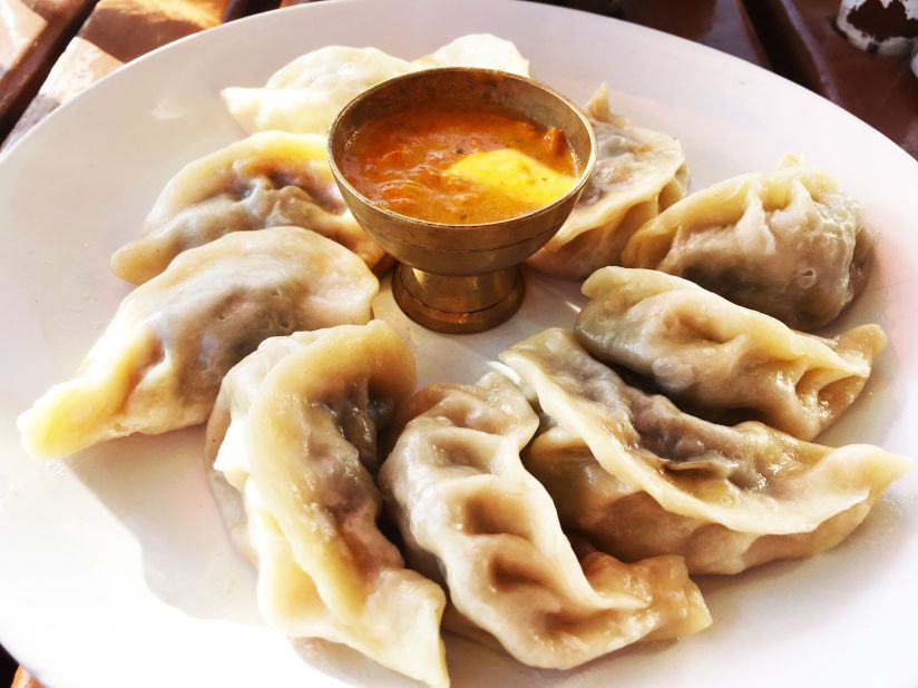 These momos are served with a curry-based sauce.
