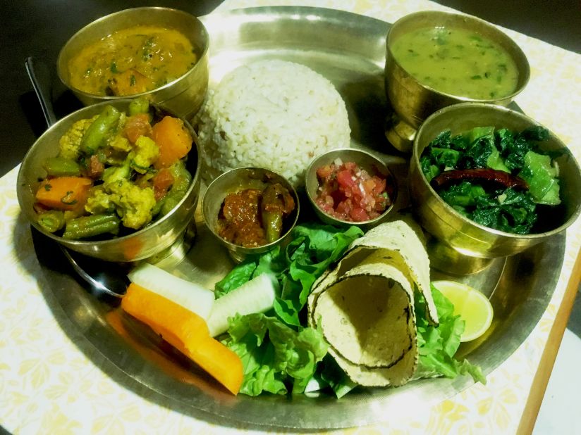 Presentation is everything in Nepalese cuisine: here dal bhat is served with the usual trappings on a metal tray. Nepalese food is typically lighter than Indian cuisine, with leaner curries that are tomato- rather than cream-based.