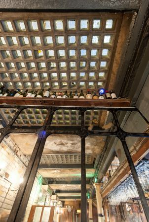 The original ceiling allows natural light to enter the space during the day time -- before the bar turns to candles to set the mood at night.