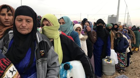 Hundreds spend their day lining up for supplies; it is cold, and people's patience is wearing thin.