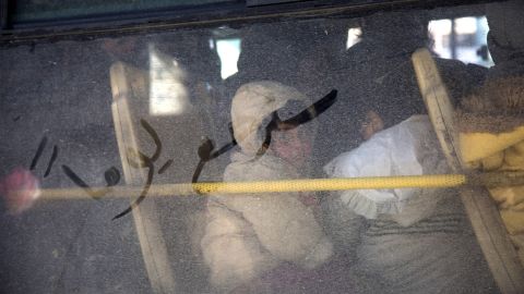 <strong>December 15: </strong>Arabic writing that reads "some day we will return" is seen on a bus window as civilians evacuate Aleppo, Syria. <a href="http://www.cnn.com/2016/12/13/middleeast/gallery/battle-for-aleppo/index.html" target="_blank">The evacuations</a> began under a new ceasefire between rebels and pro-government forces. 