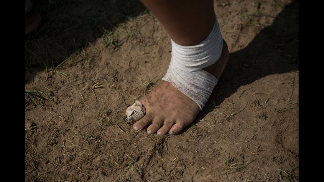 Wrestlers practice in their bare feet.