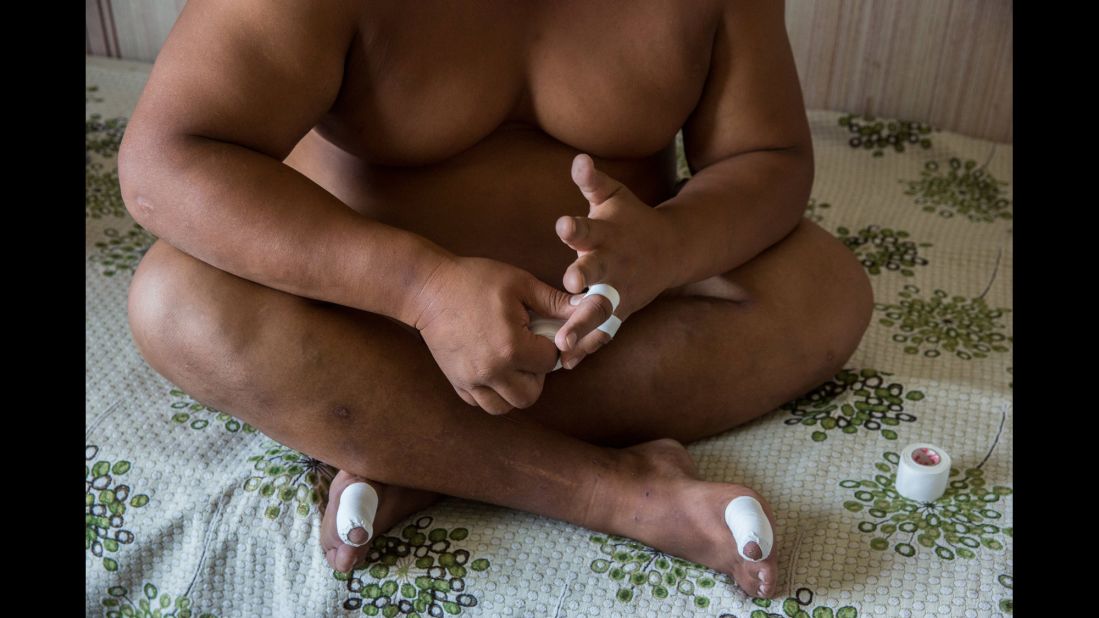 A wrestler tapes his hands as he prepares for practice.