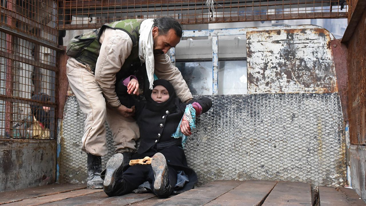 TOPSHOT - A wounded Syrian woman from the al-Sukari neighbourhood is helped onto the back of a truck as she flees during the ongoing government forces military operation to retake remaining rebel-held areas in the northern embattled city of Aleppo on December 14, 2016. 
Shelling and air strikes sent terrified residents running through the streets of Aleppo as a deal to evacuate rebel districts of the city was in danger of falling apart.

 / AFP / George OURFALIAN        (Photo credit should read GEORGE OURFALIAN/AFP/Getty Images)