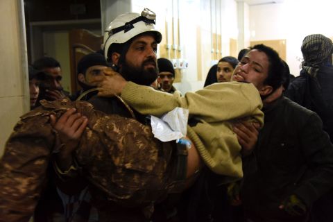 A member of the civil defense carries a wounded boy out of a hospital in eastern Aleppo on December 15.