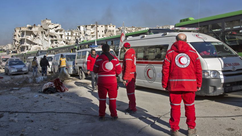 Staff of the Syrian Red Crescent are seen during an evacuation operation of rebel fighters and their families from rebel-held neighbourhoods in the embattled city of Aleppo on December 15, 2016.
A convoy of ambulances and buses left rebel territory in Aleppo in the first evacuations under a deal for opposition fighters to leave the city after years of fighting. The rebel withdrawal will pave the way for President Bashar al-Assad's forces to reclaim complete control of Syria's second city, handing the regime its biggest victory in more than five years of civil war.




 / AFP / KARAM AL-MASRI        (Photo credit should read KARAM AL-MASRI/AFP/Getty Images)