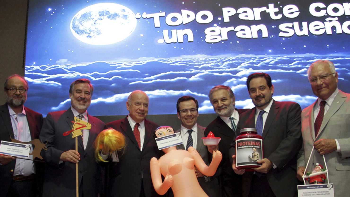 Chile Economy Minister Luis Cespedes poses with other lawmakers with a gift of an inflated sex toy.