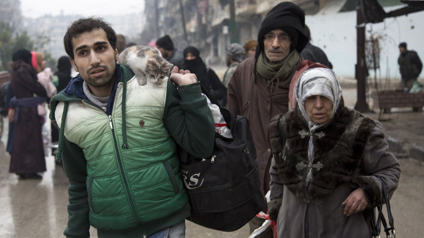 Syrians depart a rebel-controlled area of Aleppo on December 13.