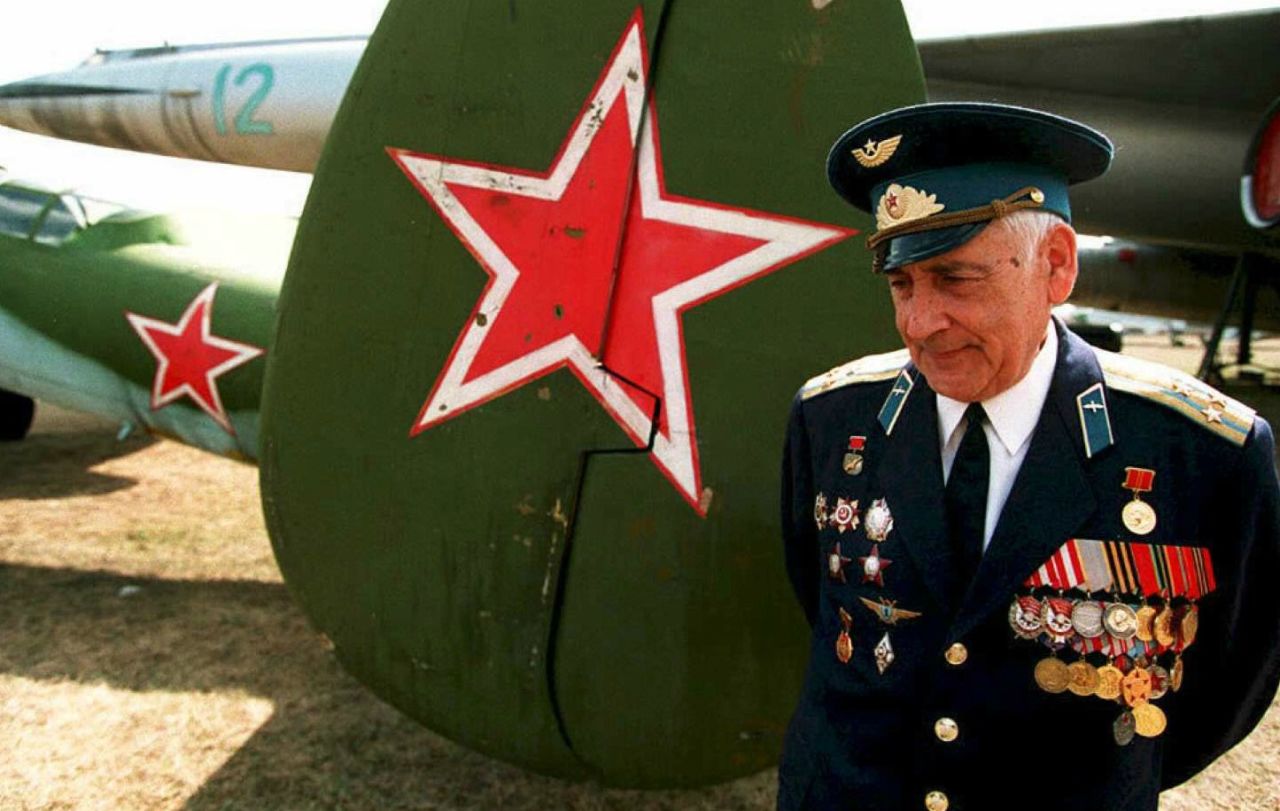 Veteran Vladimir Yermakov stands next to a TU-2 bomber, an airplane he flew during World War II and which is now on display at the Monino Aviation Museum near Moscow. 