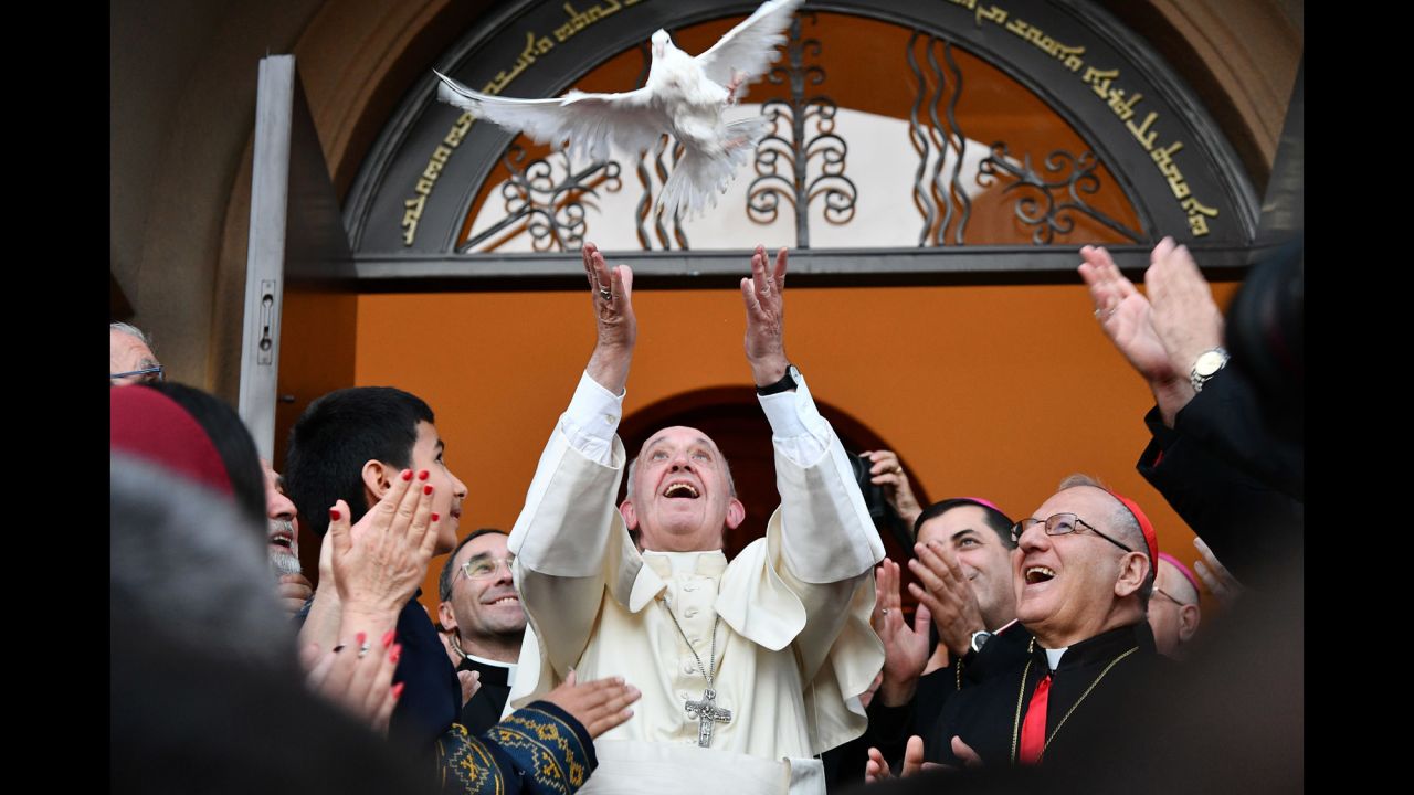Pope Francis looks on with joy as he releases a dove as a symbol of peace during a meeting with the Assyrian Chaldean community at the Catholic Chaldean Church of St. Simon Bar Sabbae in Tbilisi, Georgia, on September 30, 2016.