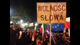 A demonstrator holds a sign reading "Freedom of Speech" outside the Polish parliament building Friday.