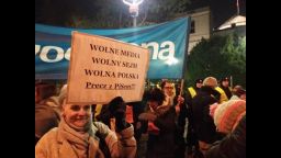 A woman holds a sign reading "Free media, free parliament, free Poland" during Friday's protest outside the legislature.