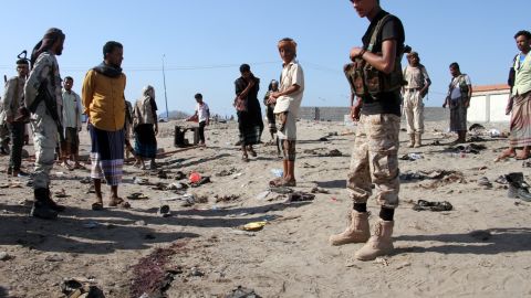 Yemenis gather at al-Sawlaba base in Aden's al-Arish district  after a suicide bomber targeted a crowd of soldiers. 
