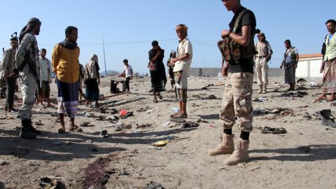 Yemenis gather at al-Sawlaba base in Aden's al-Arish district after a suicide bomber targeted a crowd of soldiers.