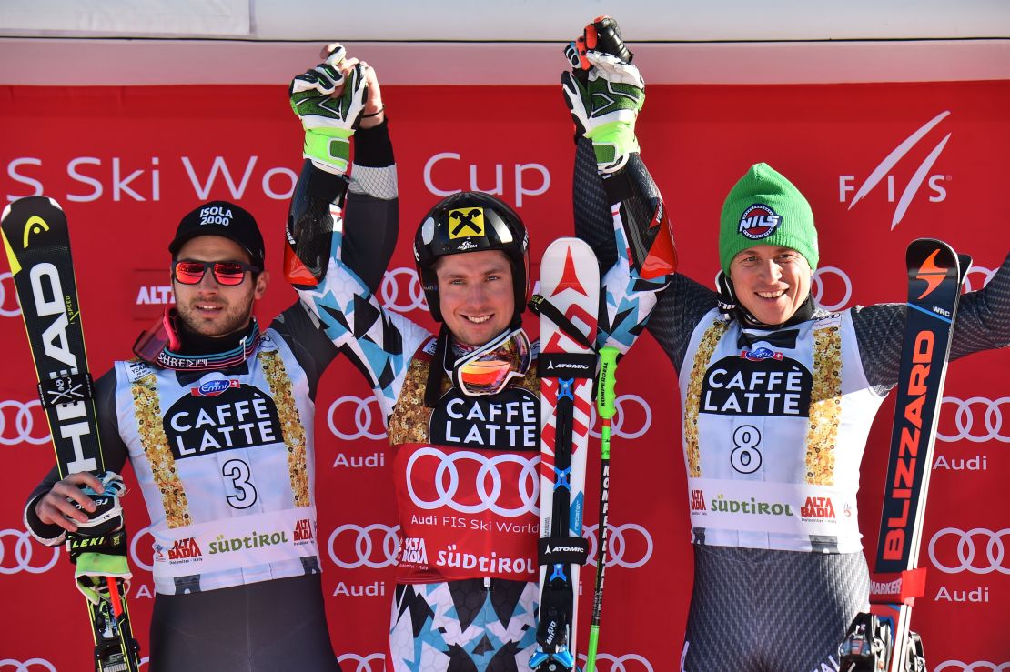 Marcel Hirscher is flanked by France's Mathieu Faivre (left) and Italy's Florian Eisath on the podium at Alta Badia.