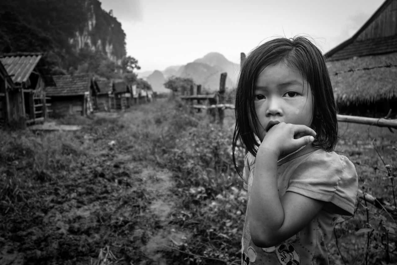 Riding a motorbike allows you to visit tiny villages that public buses can't get to. While it's foolish to believe you are the "first foreigner" a person has ever seen, it's not uncommon to spend time with villagers that have rarely connected with an international visitor before, such as this intensely curious young girl in Tan Hoa village. 