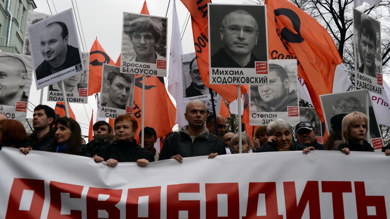 Thousands of Russians carry placards of political prisoners including Khodorkovsky and a banner reading "Freedom!" during an opposition rally in Moscow in 2013. 