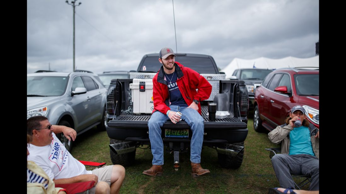 John Bonner, center, tailgates with friends outside the stadium before the rally.