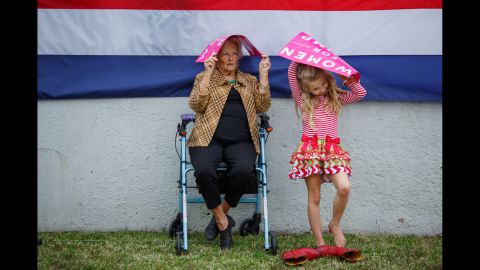 Mary Nell Moseley and her 8-year-old great granddaughter Lilly Key try to stay dry as they wait for Trump to speak. "I think he'll be wonderful for women," Moseley said. "I think he's gonna be good for everybody."